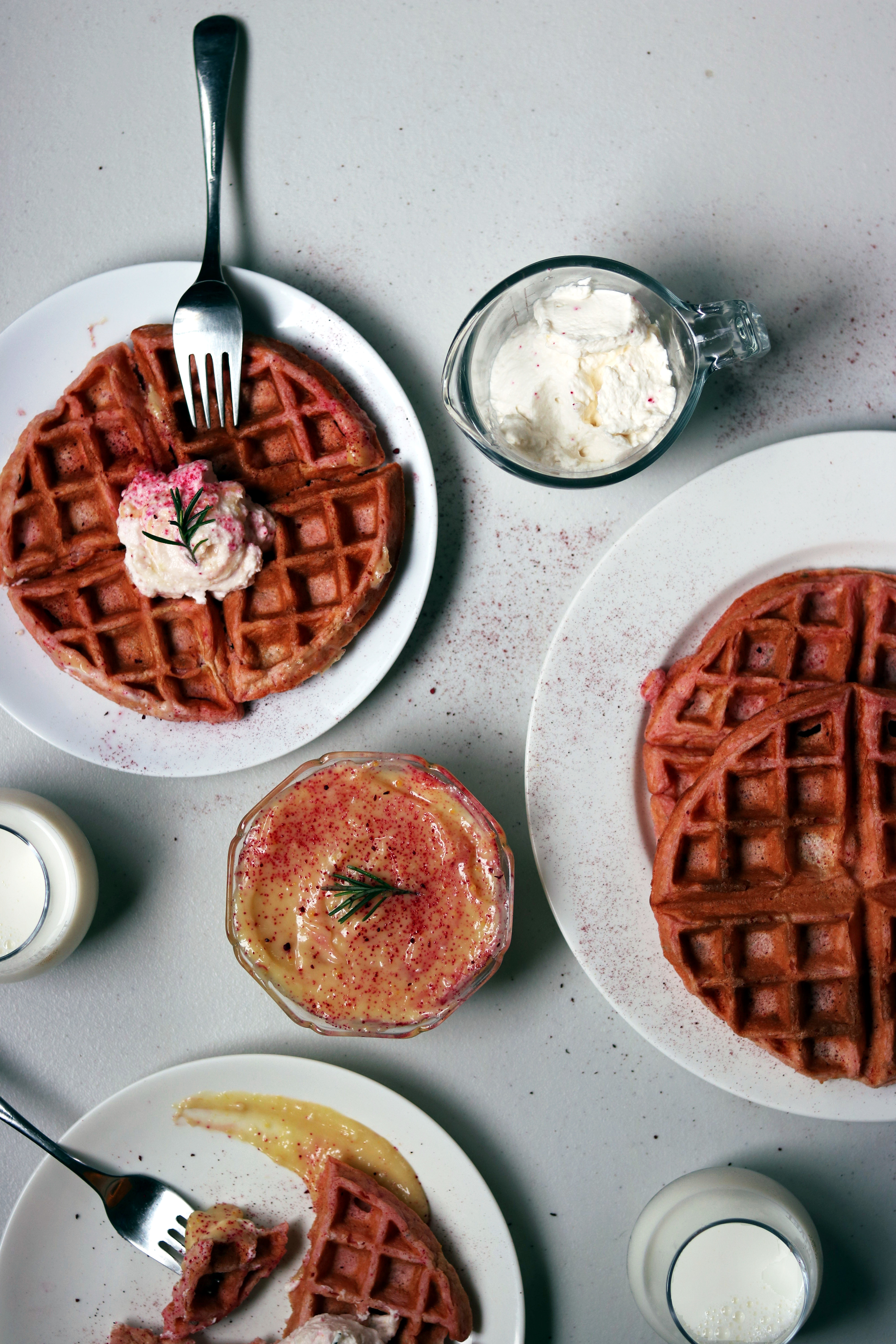These pink rosemary and lemon Belgian waffles are the perfect way to say I love you for Valentine's day or for any time you are hosting brunch! They sound so gourmet and fancy, but they are a piece of cake (er waffle?) to make! The tart lemon curd and delicate woodiness of the rosemary will have your guests so impressed! And I have a little trick for you that will guarantee the fluffiest waffles time and time again. It takes hardly any extra time and will elevate your waffles from diner to gourmet. Valentine's Day Recipes | Lemon Curd | Belgian Waffle Recipes | Brunch Recipes